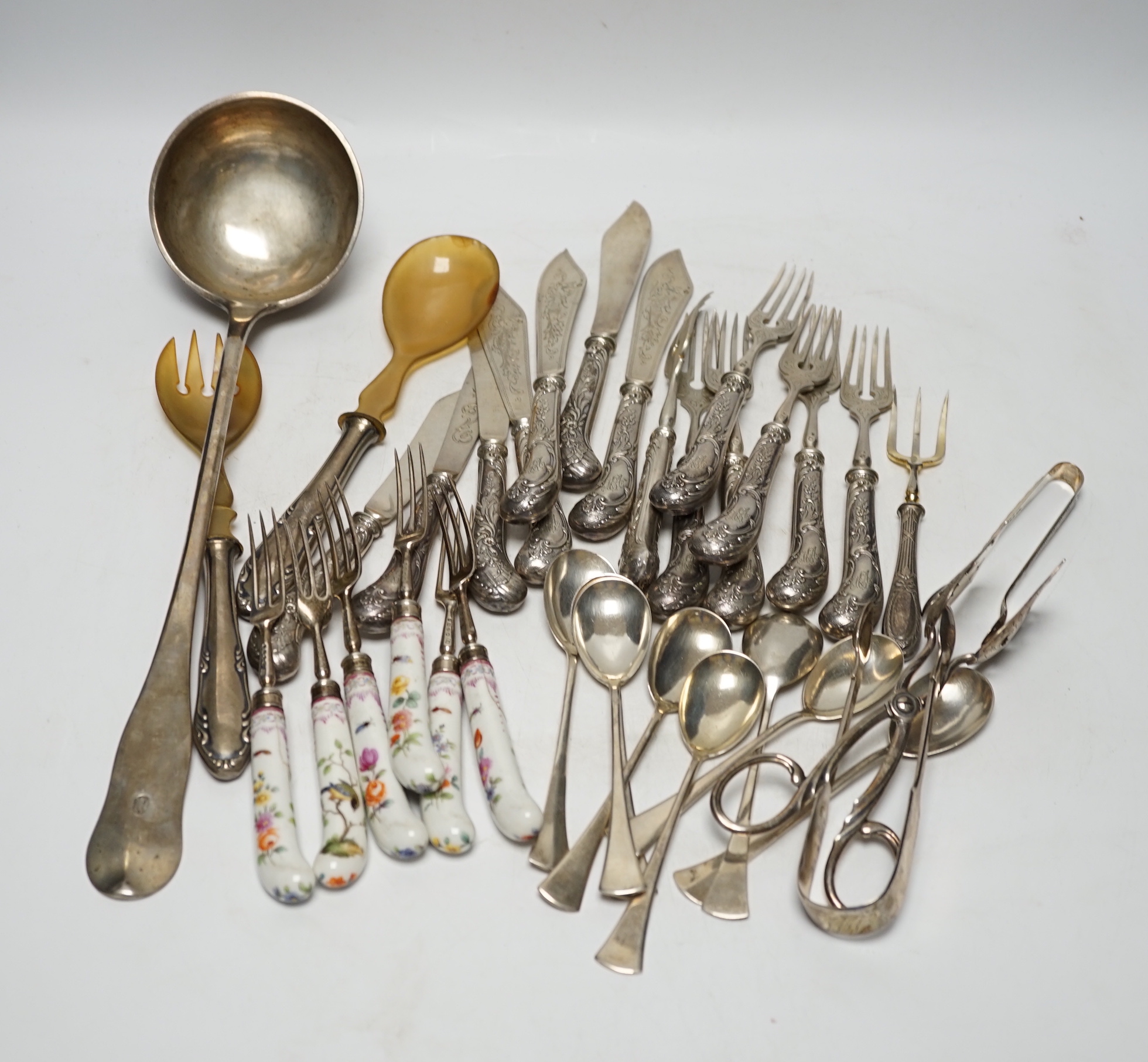 Six Victorian silver dessert forks by George Adams, London, 1880, with Meissen handles, 17.5cm(a.f.), eight 800 standard sorbet spoons, seven pairs of Austro-Hungarian white metal fish eaters, five other continental item